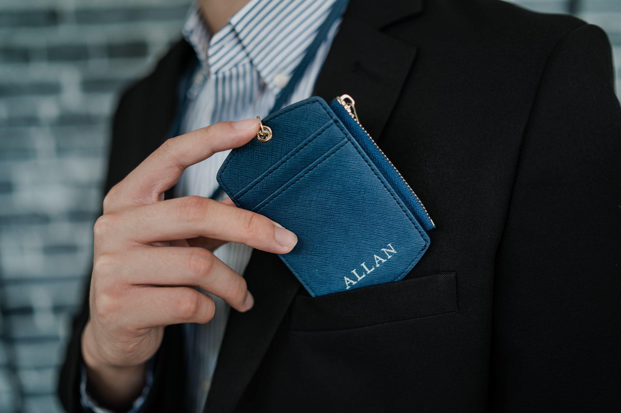 hand holding ID cardholder with lanyard and zipper in navy