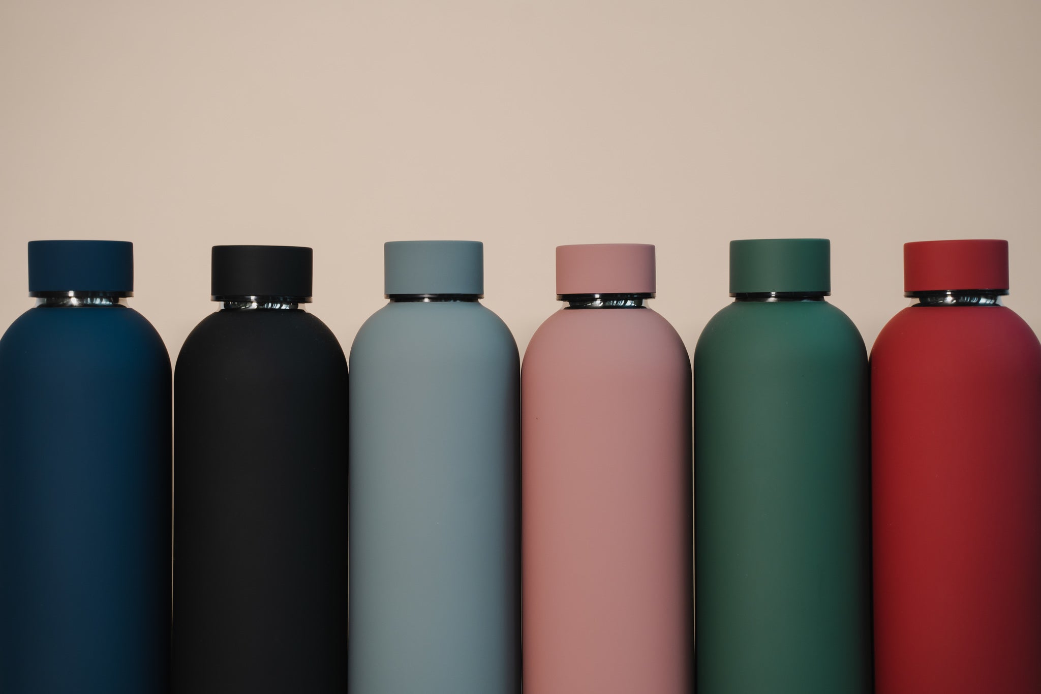 Assortment of colourful customised water bottles