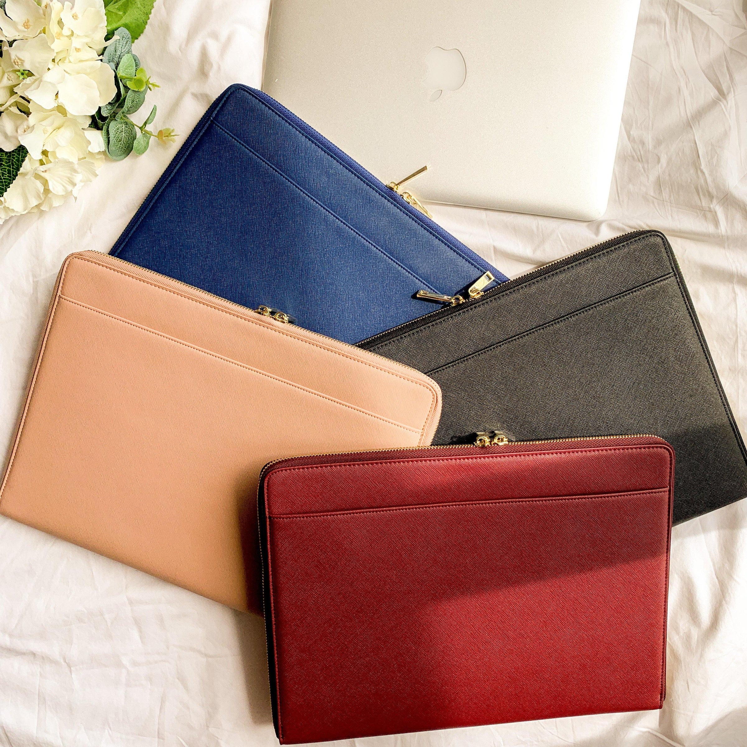 collection of leather laptop bags and sleeves