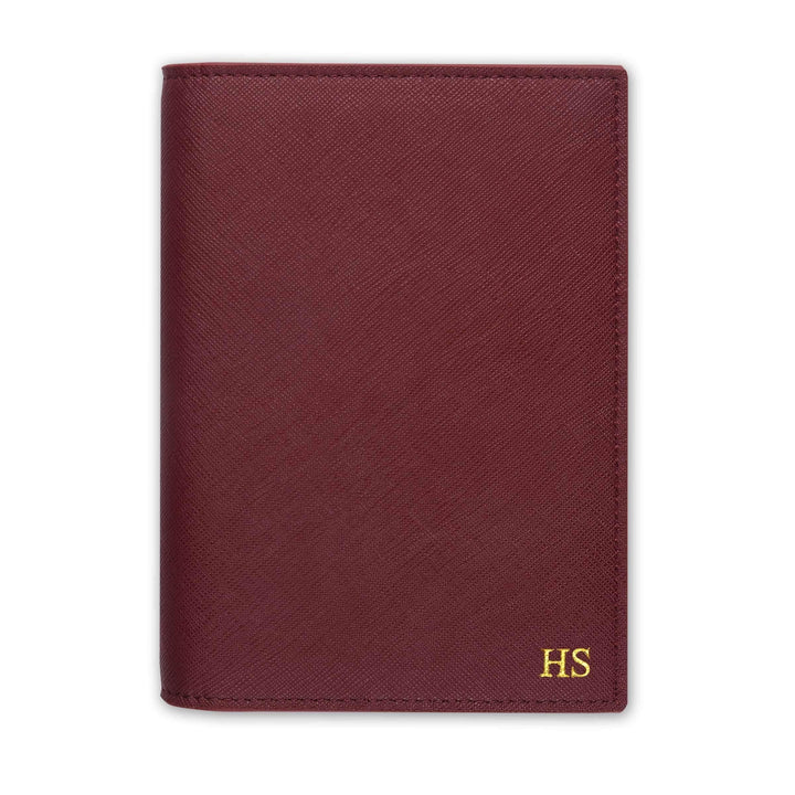 Saffiano passport cover in burgundy with gold HS text