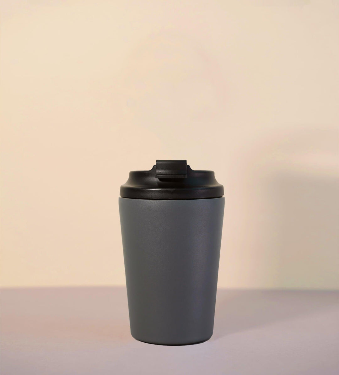 Gray thermal bottle with black lid for coffee